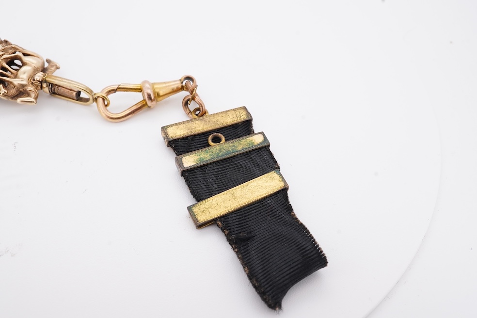 A late Victorian yellow metal overlaid and citrine set watch key fob, depicting two horses and two rams?, 30mm on a black sash suspension, together with a modern pair of 9ct gold and cultured pearl set leaf ear studs. Co